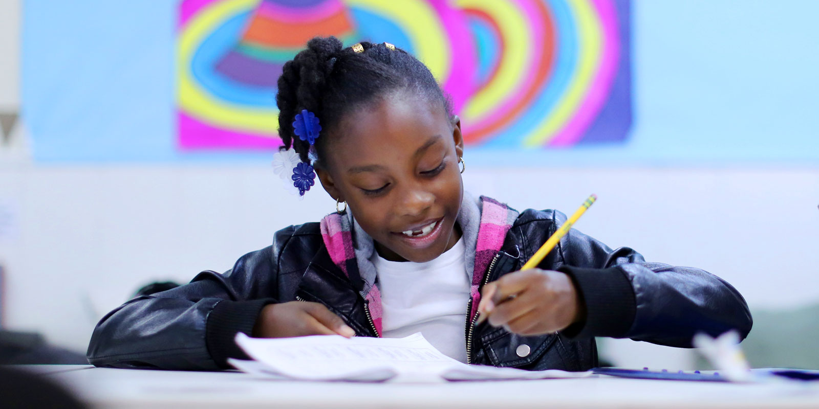 Student working on classwork at Crete Academy. Student smiling and working on classwork at Crete Academy.