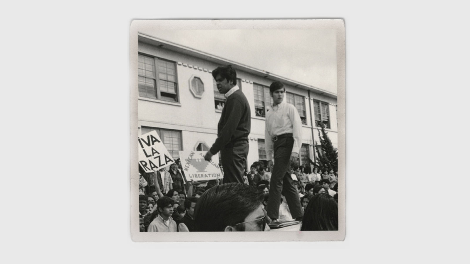 Protestors atop a vehicle during the 1968 Walkout. Photo courtesy of Raul Ruiz. Protestors atop a vehicle during a 1968 rally in East L.A.