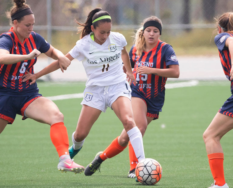 Paulina Chaidez splits three Fresno Pacific soccer players. Paulina Chaidez splits three Fresno Pacific soccer players.
