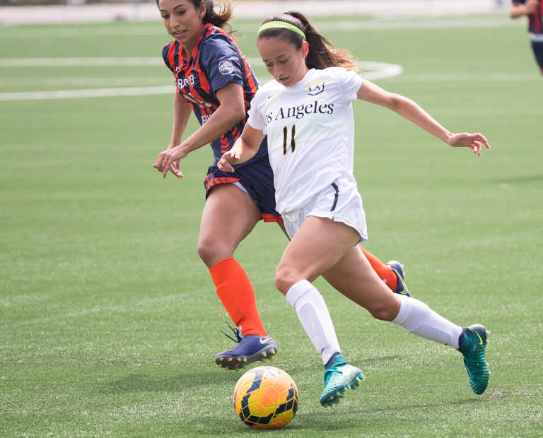 Paulina Chaidez dribbles past opposing defender. Paulina Chaidez dribbles past opposing defender.