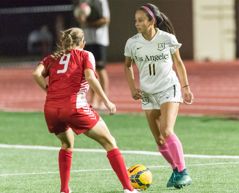 Paulina Chaidez looks for teammates up the field. Paulina Chaidez looks for teammates up the field while dribbling the ball.