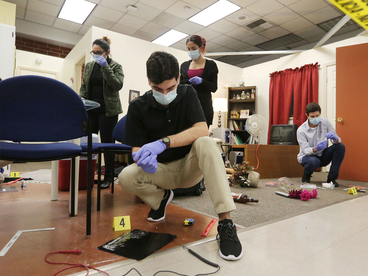 Criminalistics students stage a mock crime scene in the Hertzberg-Davis Forensic Science Center. Criminalistics students stage a mock crime scene in the Hertzberg-Davis Forensic Science Center.