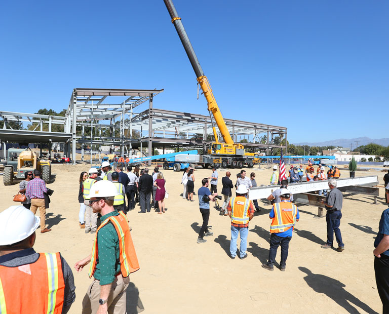 Members of the LAFC and Cal State LA participate in a pole-topping ceremony on the construction site. Members of the LAFC and Cal State LA participate in a pole-topping ceremony on the construction site.