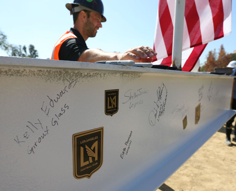 Members of the LAFC and Cal State LA sign the last pole at the construction site. Members of the LAFC and Cal State LA sign the last pole at the construction site.