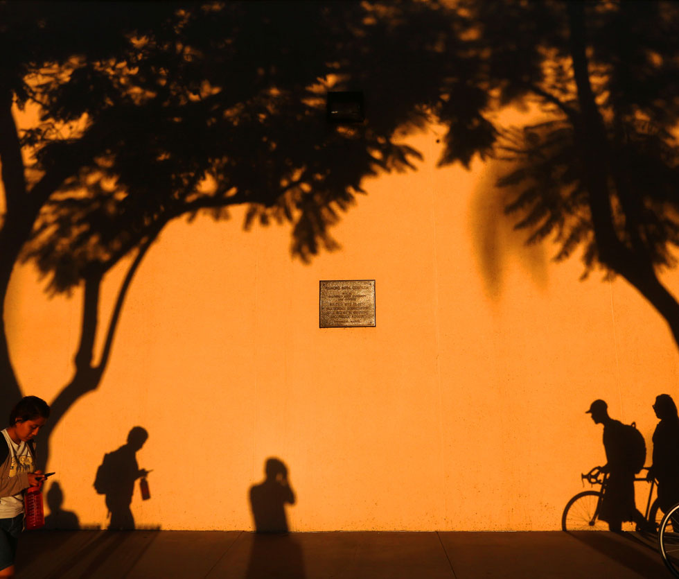 Photographer Emilio Flores captures his shadow on camera in front of administration building. Photographer Emilio Flores captures his shadow on camera in front of administration building.