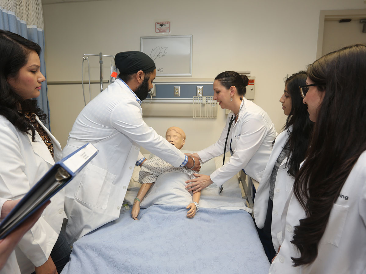 Nursing students demonstrating their skills in the Patricia A. Chin School of Nursing Nursing students demonstrating their skills in the Patricia A. Chin School of Nursing