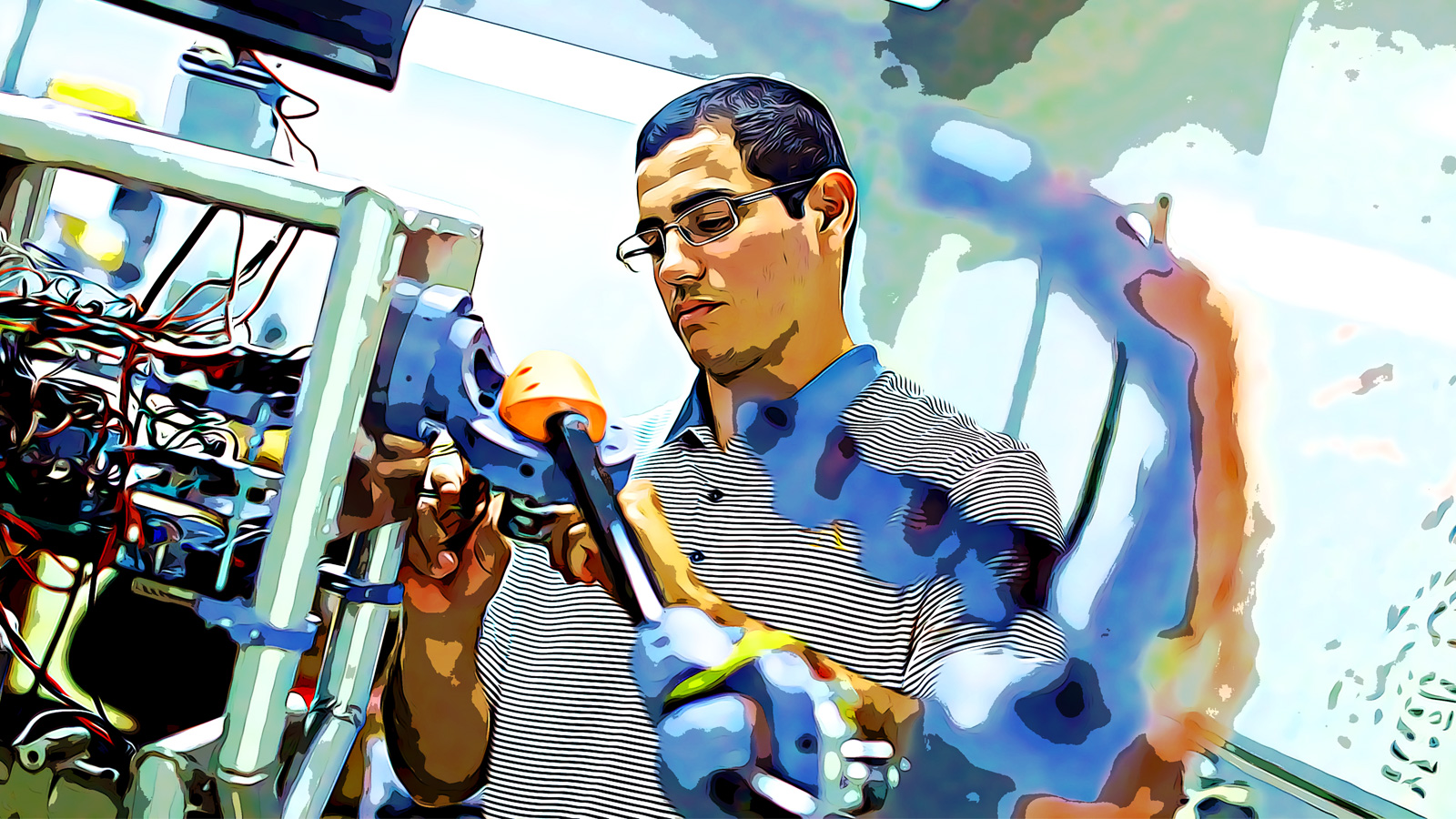 Salvador Rojas working on a piece of technology in a lab. Salvador Rojas working on a piece of technology in a lab.