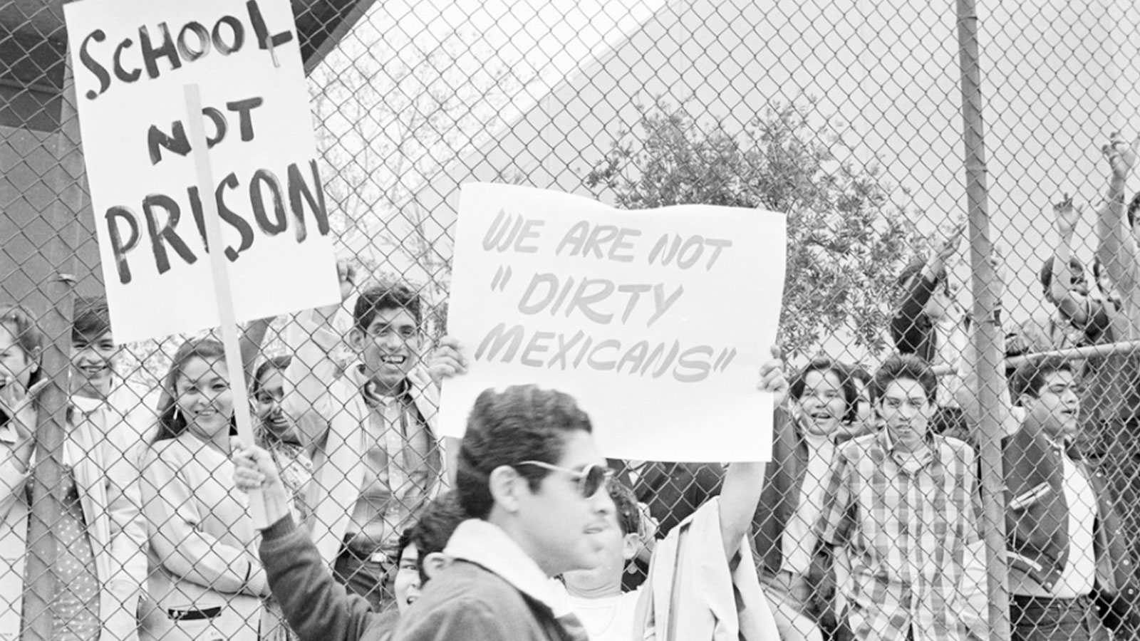 Cal State LA students during the walkouts holding protest signs. One reading "We are not 'Dirty Mexicans'" and the other reading "School Not Prison". Cal State LA students during the walkouts holding protest signs. One reading "We are not 'Dirty Mexicans'" and the other reading "School Not Prison".