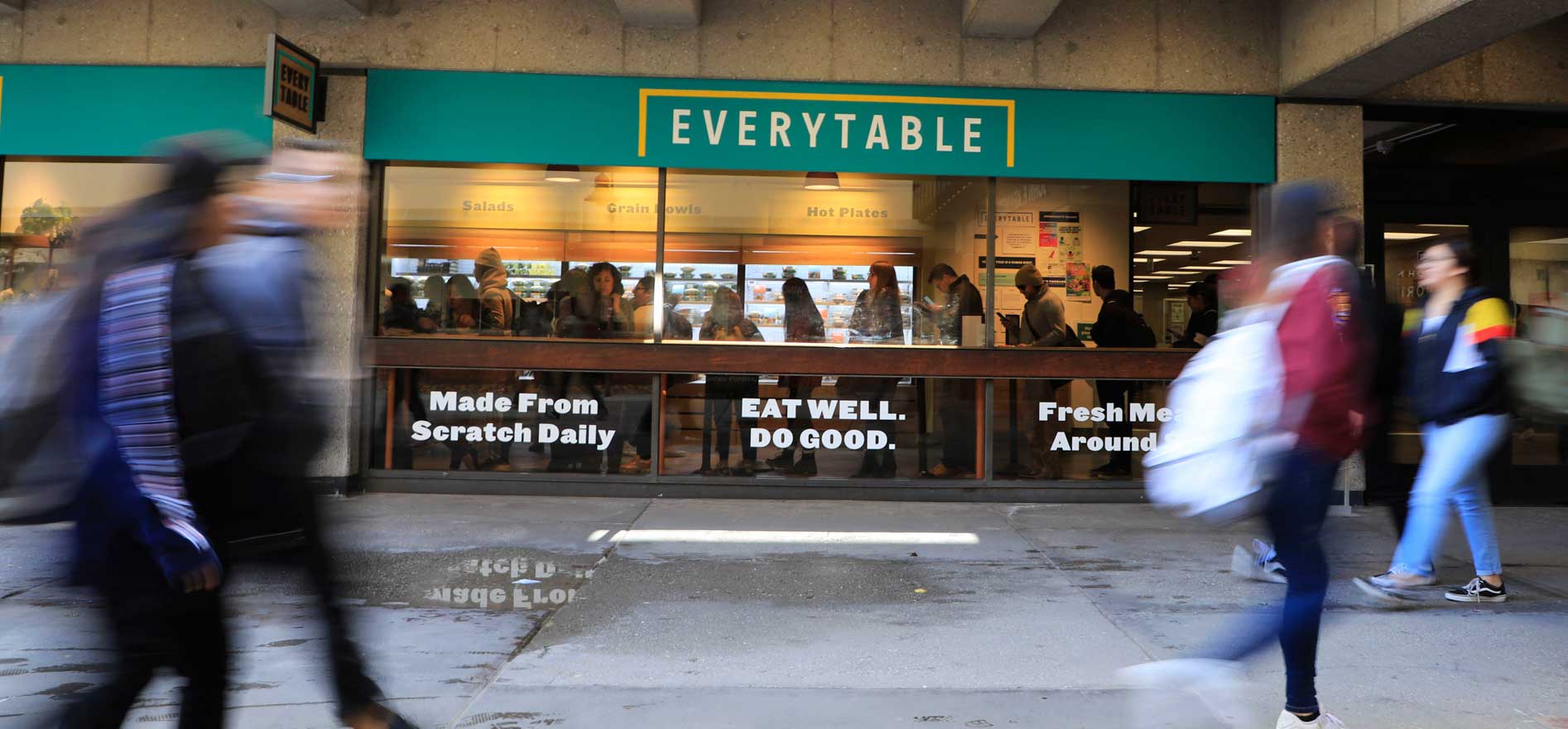 Students walking by Cal State LA's Everytable storefont.