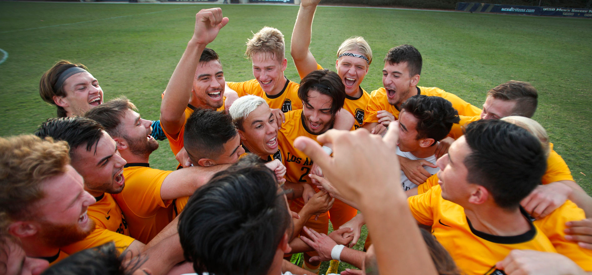 Cal State LA Golden Eagles Men's Soccer team celebrating on the soccer field.