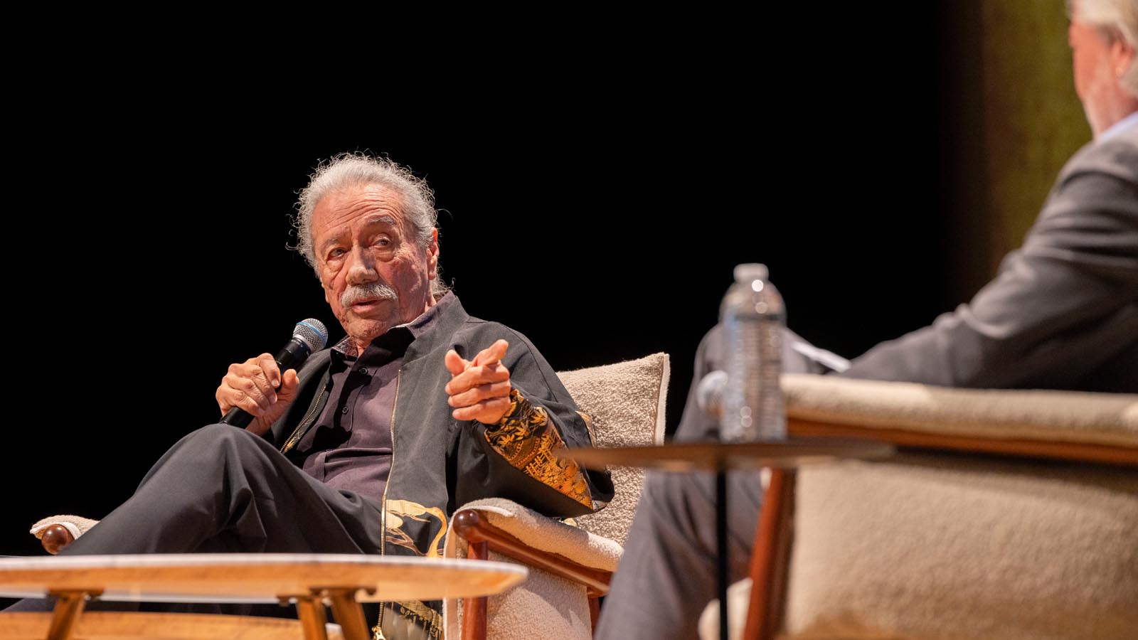 Actor Edward James Olmos speaks on stage during a conversation event at Cal State LA’s Community Weekend, sharing insights with the audience.