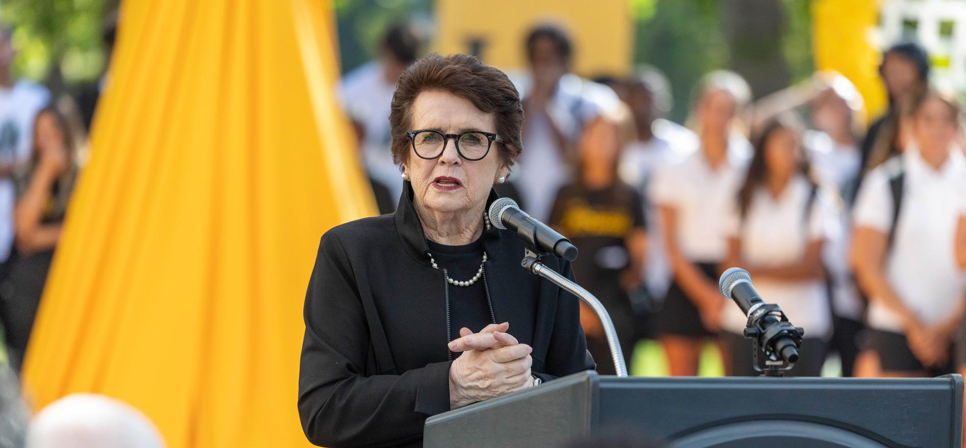 Billie Jean King speaks from a podium.
