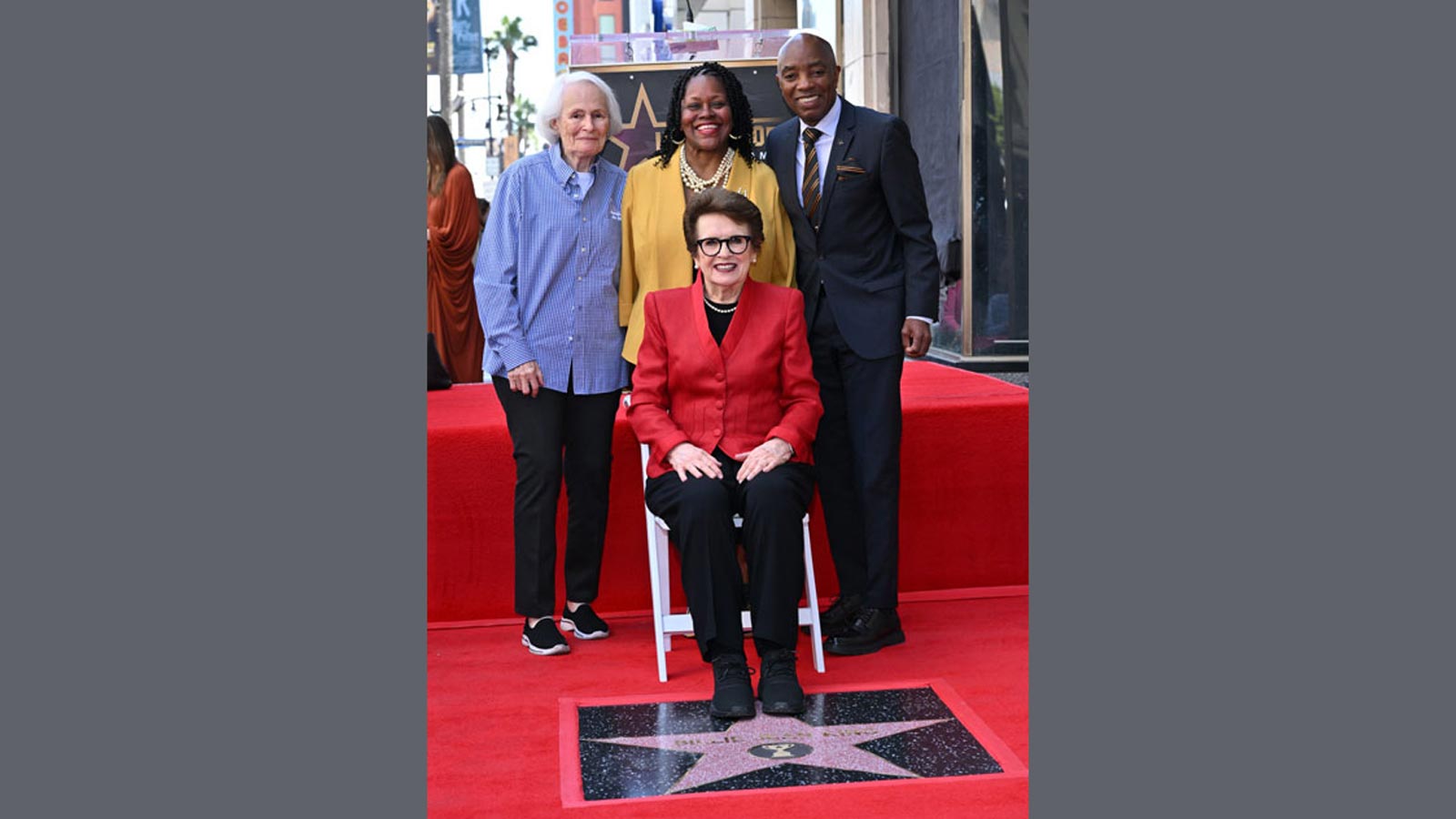 Billie Jean King sits beside her newly unveiled Hollywood Walk of Fame star, joined by Cal State LA President Berenecea Johnson Eanes and guests during the ceremony.