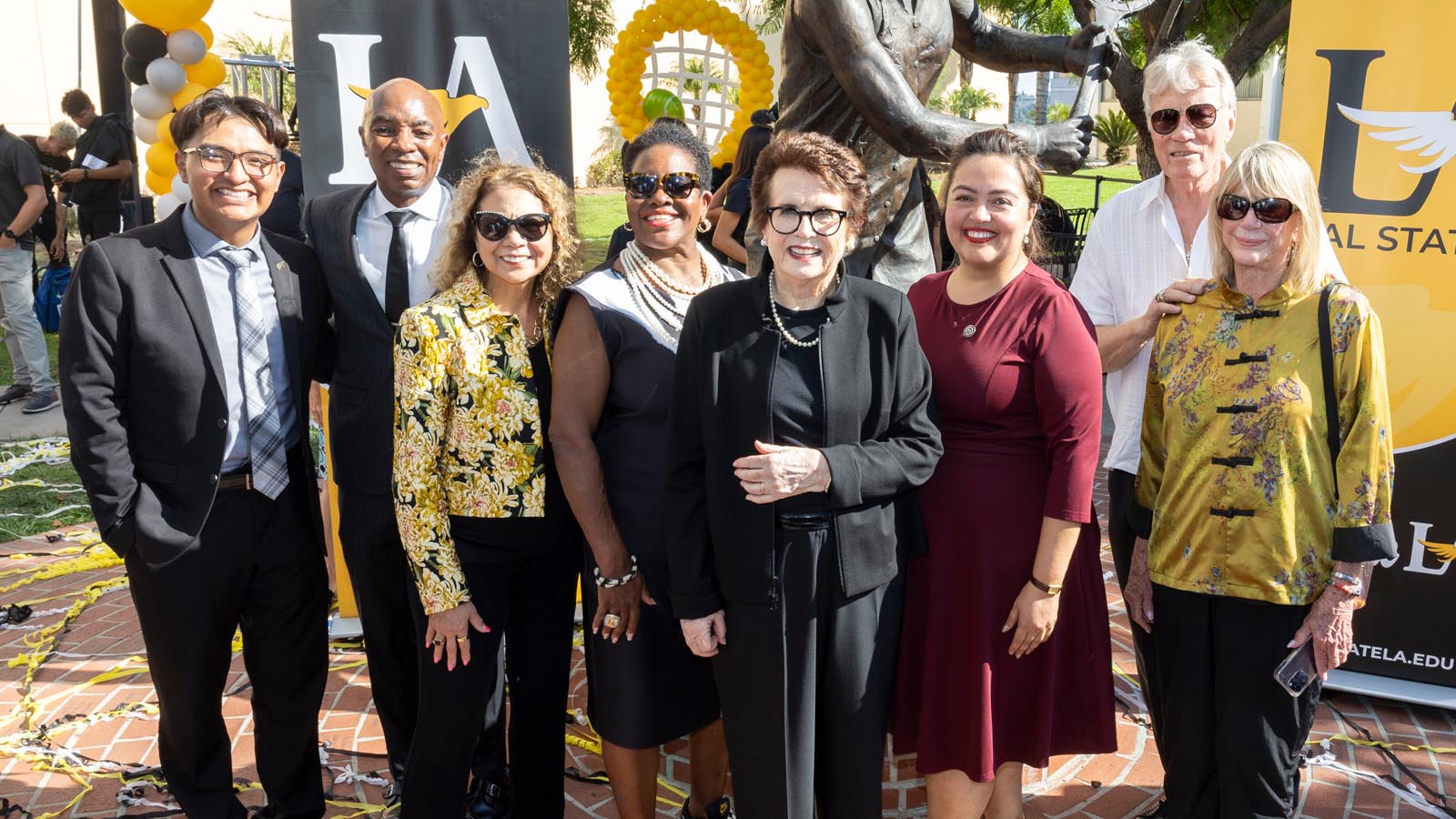 Cal State LA President Berenecea Johnson Eanes, Billie Jean King, and University guests gather in front of the Billie Jean King statue following the campus dedication ceremony.