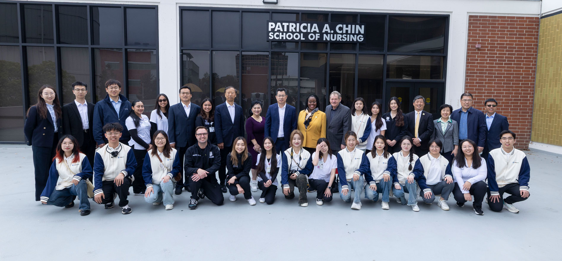 Cal State LA President Berenecea Johnson Eanes joins faculty, staff, and visiting students from Binzhou Medical University for a group photo outside the Patricia A. Chin School of Nursing.
