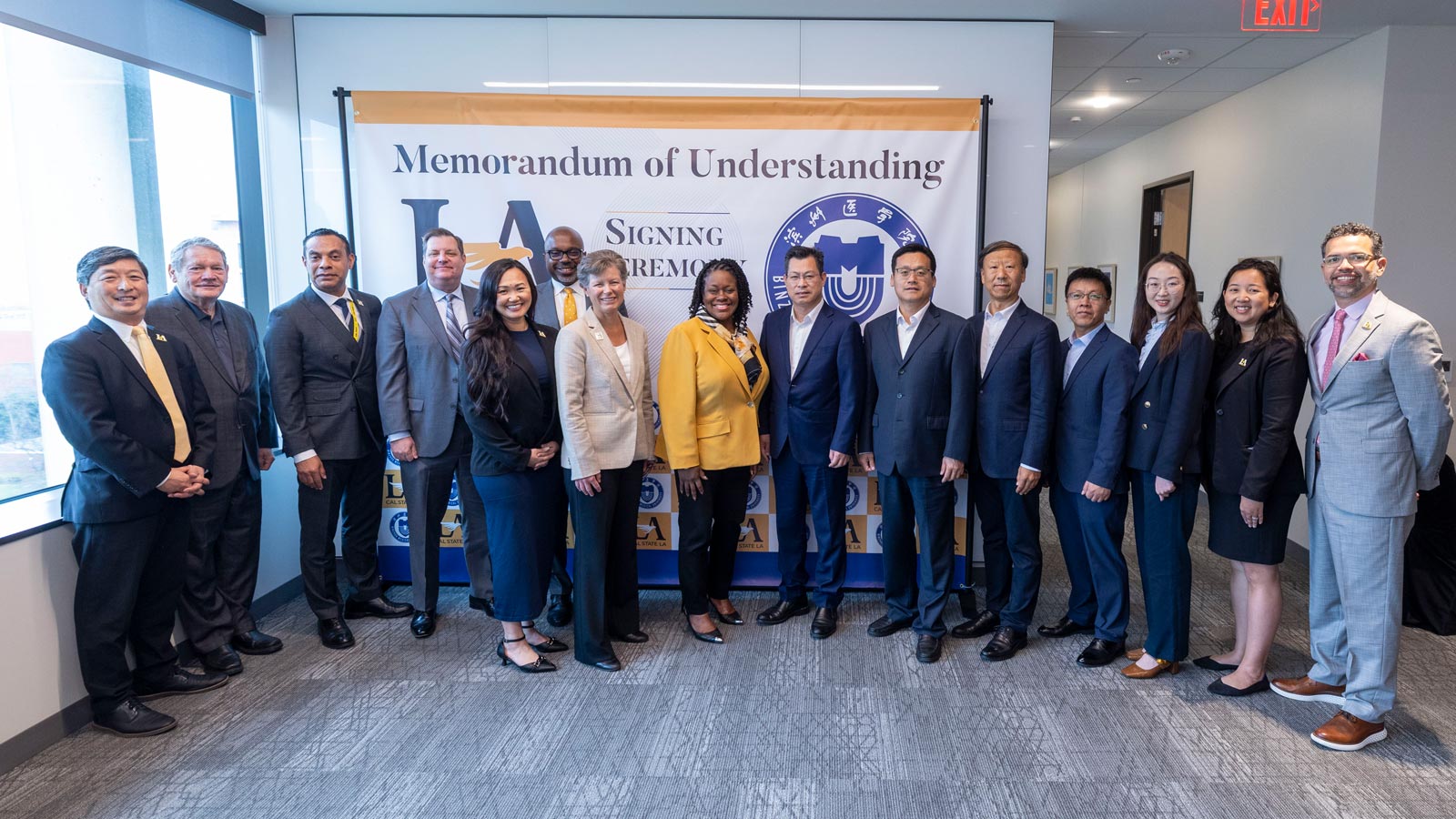 A large group of administrators taking a ohoto together in front of a white backdrop.