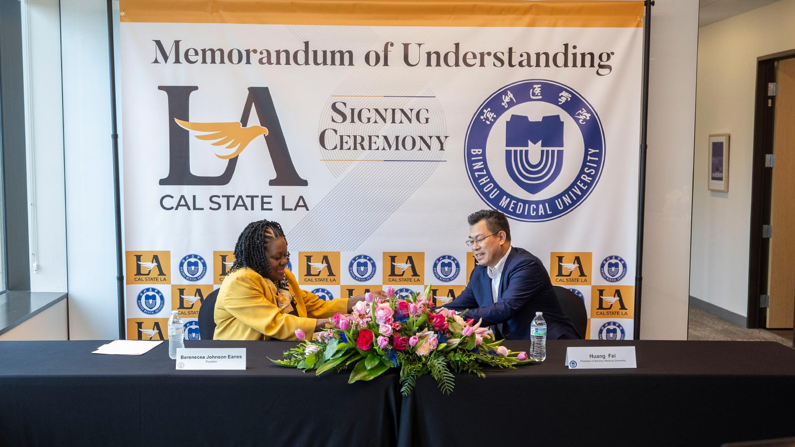 Cal State LA President Berenecea Johnson Eanes and Binzhou Medical University President Huang Fei shake hands during a memorandum of understanding signing ceremony to strengthen academic collaboration.