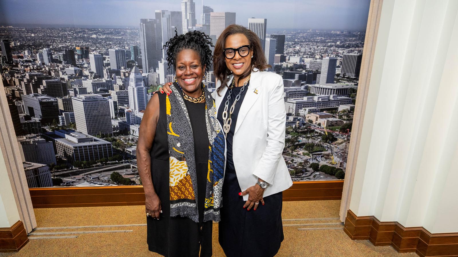 Cal State LA President and an alumn smile together at Los Angeles City Hall during Cal State LA Day 2025.