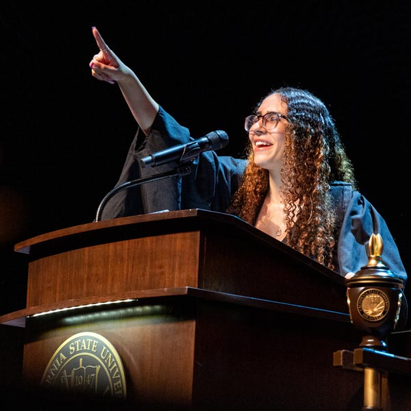 A student speaks from behind a podium.