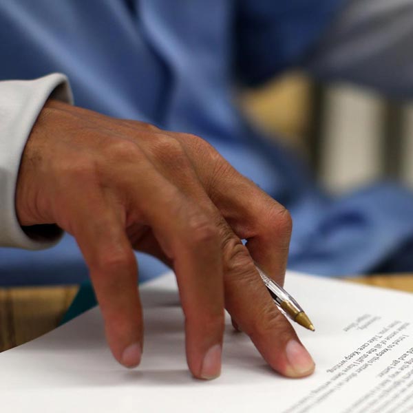 A hand holding a pen.