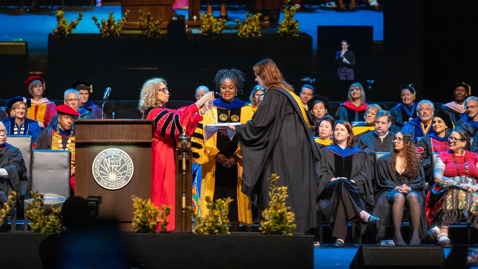 Rojas in a graduation cap, smiling brightly.