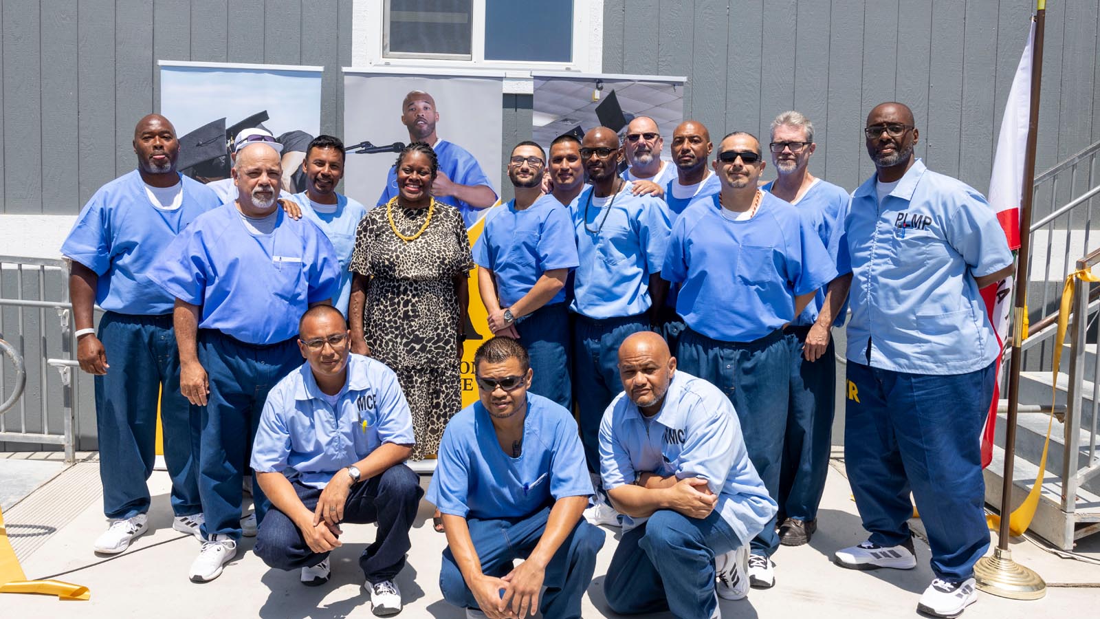 Cal State LA President Berenecea Johnson Eanes stands with students from the Prison Graduation Initiative at Lancaster State Prison during a celebratory event.