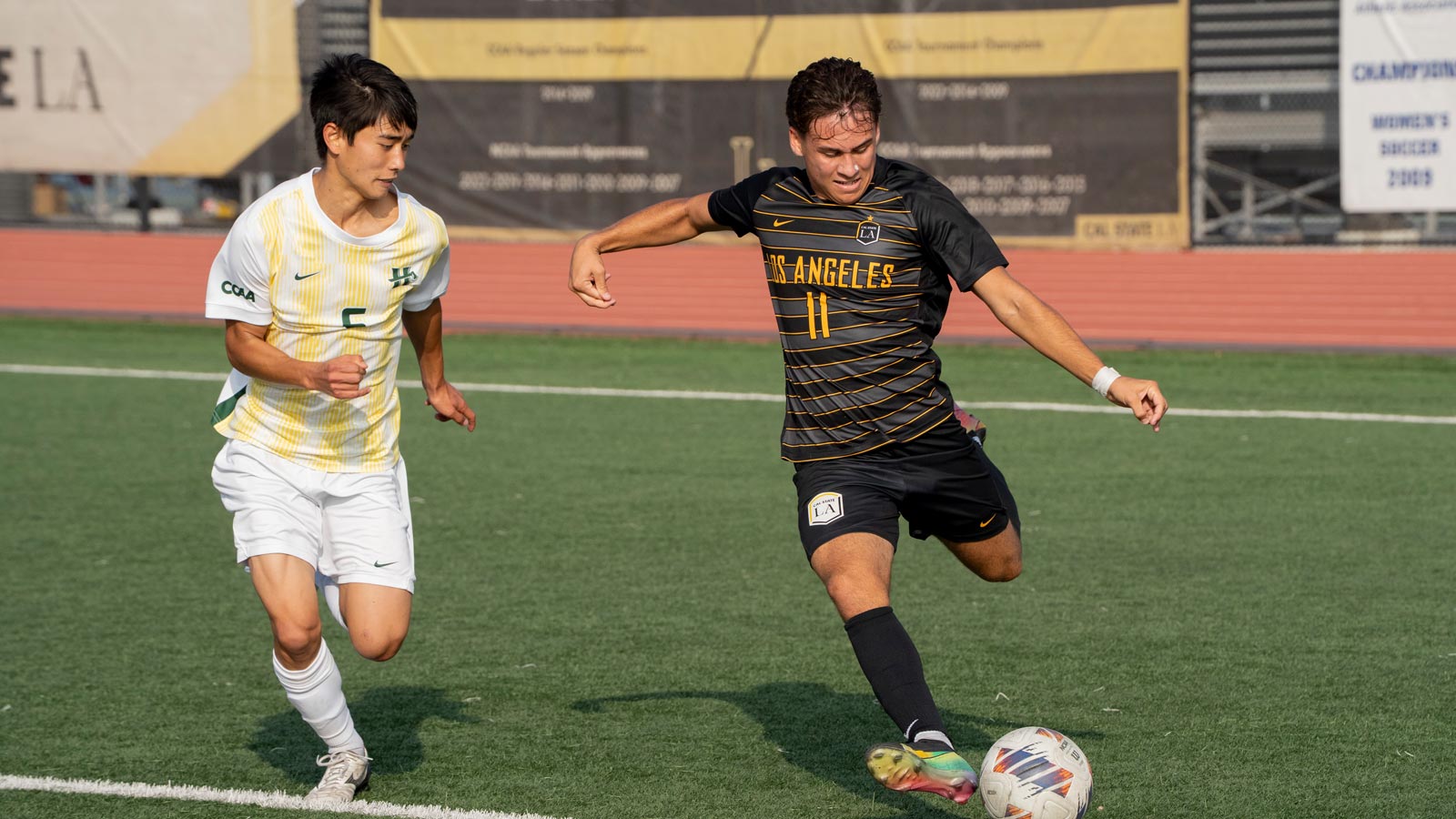 Cal State LA forward Hunter Devlyn takes a powerful shot on goal during a match at University Stadium.